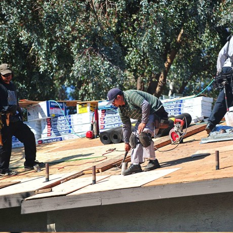 Aerial view of Western Roofing repairing a residential rooftop